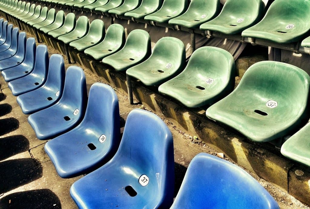Rows of blue and green stadium seats